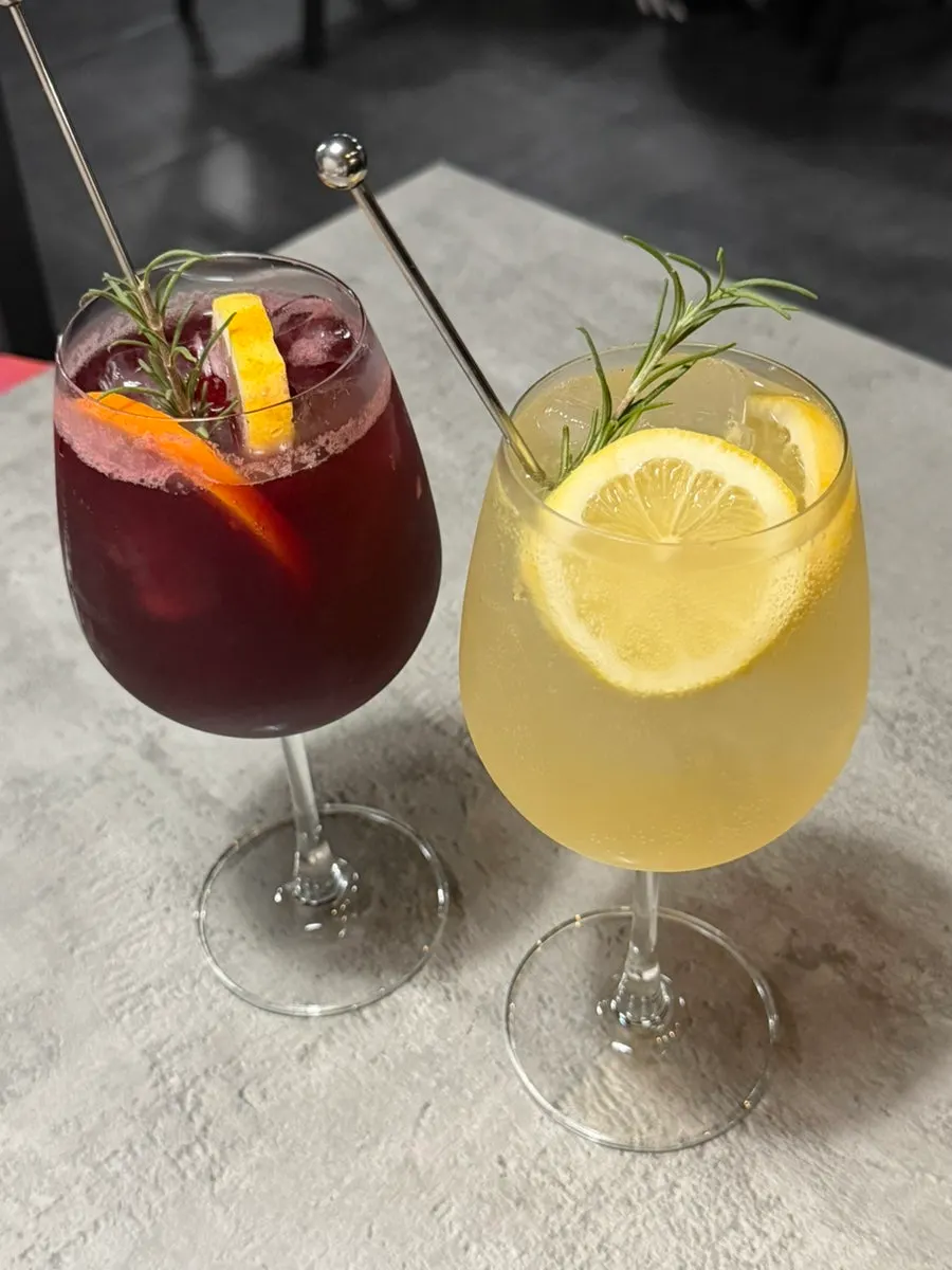 Two drinks — raspberry sangria and lemon white spritzer