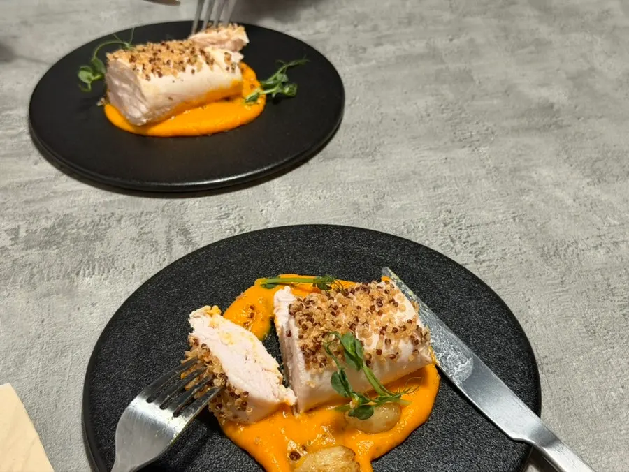 Sous vide chicken breast plating over carrot purée
