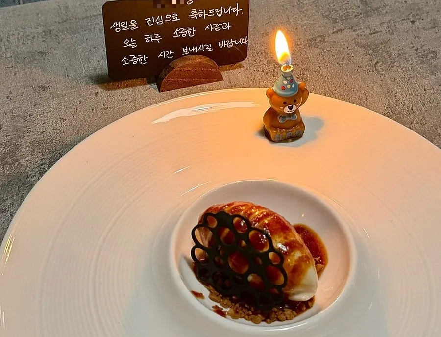 Earl Grey ice cream dessert topped with a small candle