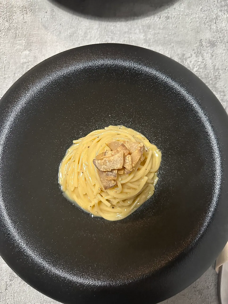 Carbonara topped with salt-cured meat