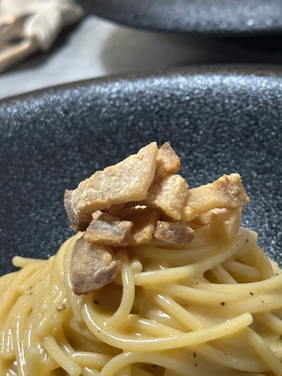 Close-up of carbonara noodles and toppings