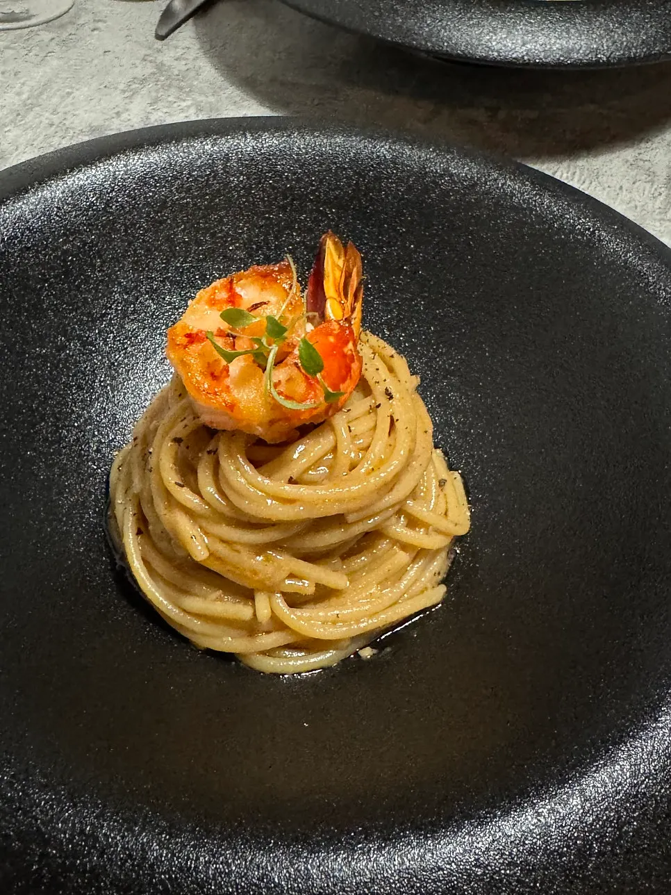 Bisque pasta topped with seared shrimp