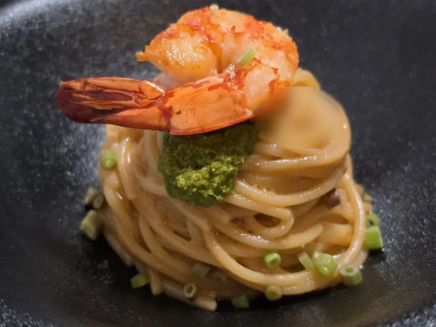 Bisque pasta topped with minari pesto and shrimp