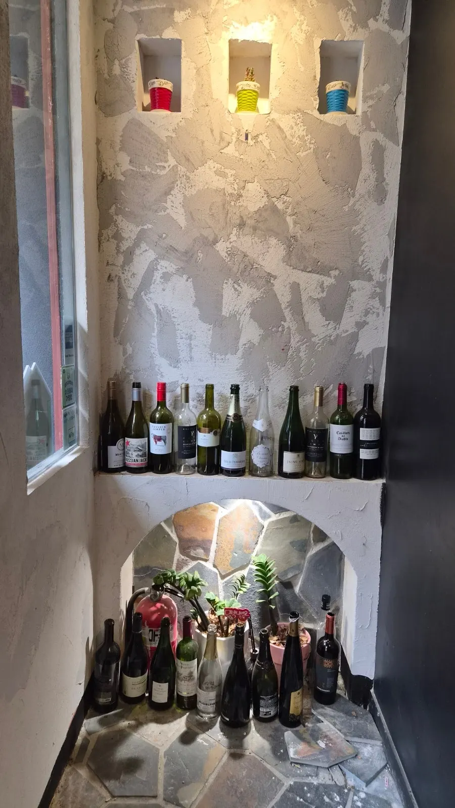 Interior wall of Hado lined with wine bottles