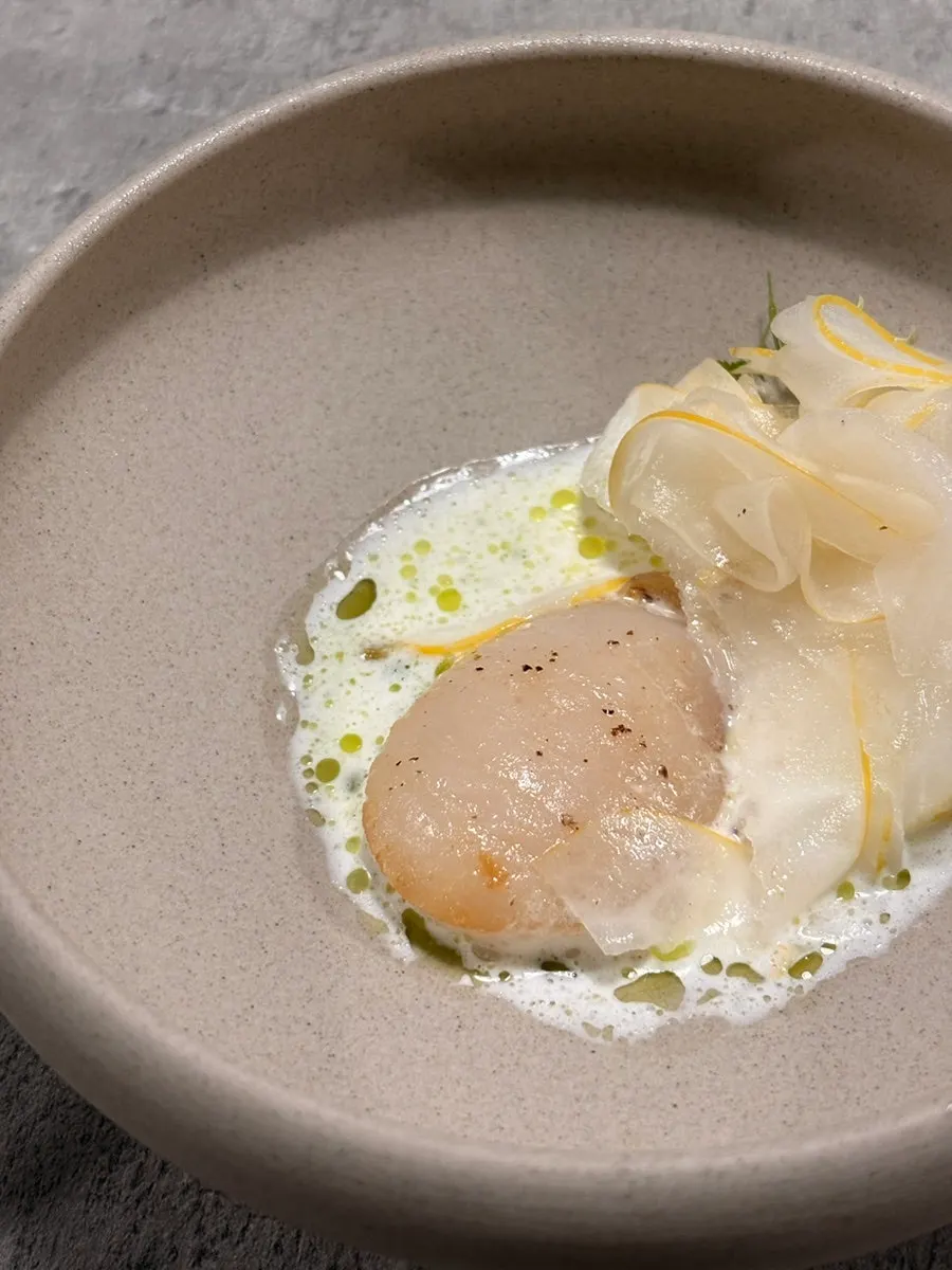 Plating of melon scallop salad