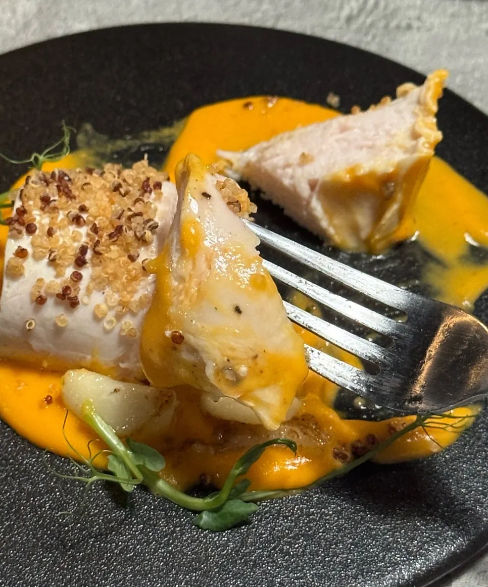 Cross-section of chicken breast topped with quinoa crunch