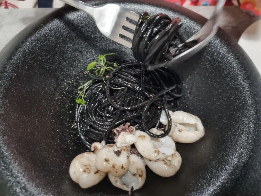 Plating of Hado's squid ink pasta and vongole pasta