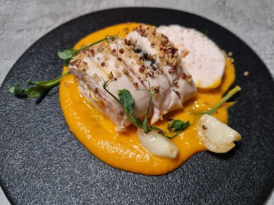 Sous vide chicken breast steak topped with grains