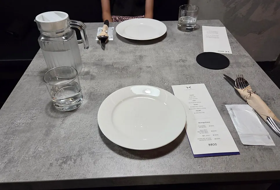 Table setting and white plates at Hado