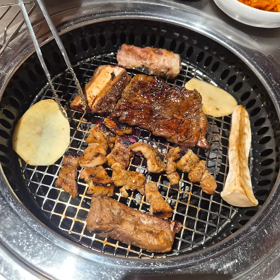 Seasoned pork ribs cooking on the grill
