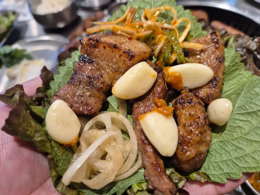 Ribs grilling alongside side dishes