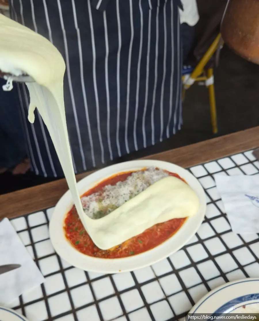Tableside cheese-waterfall lasagna performance