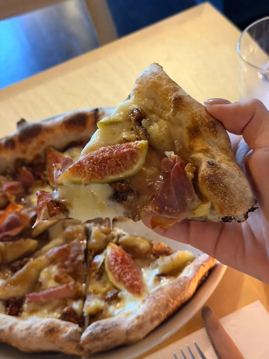 Pizza topped with figs, prosciutto, and walnuts