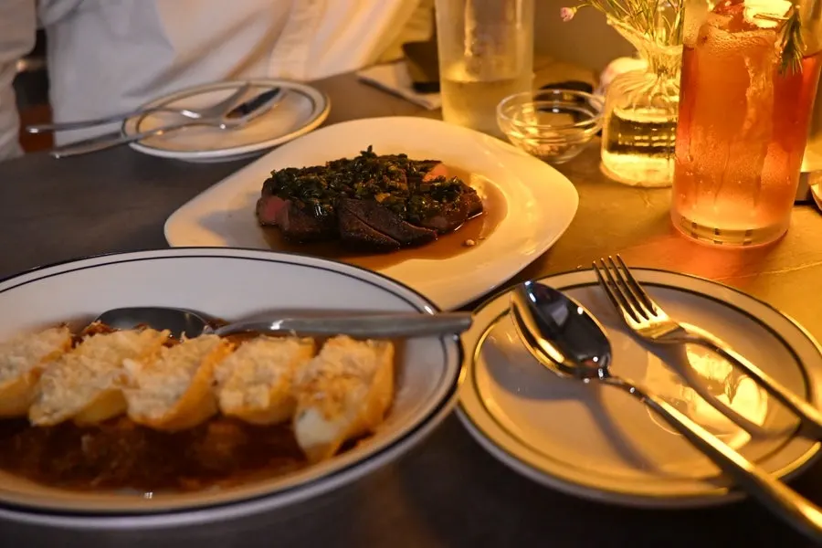 Table setting with Sugar Hill's main dishes, shell pasta and sous vide steak