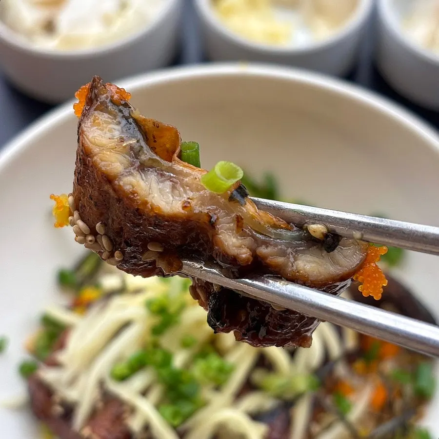 Close-up of crispy-outside, tender-inside eel soaked in special sauce