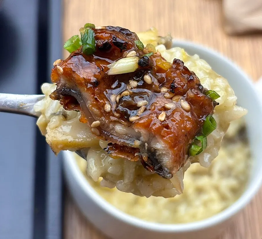 A spoonful of abalone porridge topped with eel