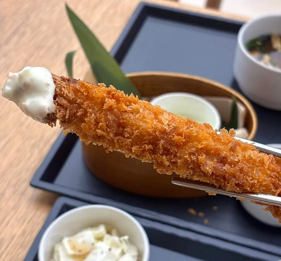 Fried shrimp dipped in tartar sauce