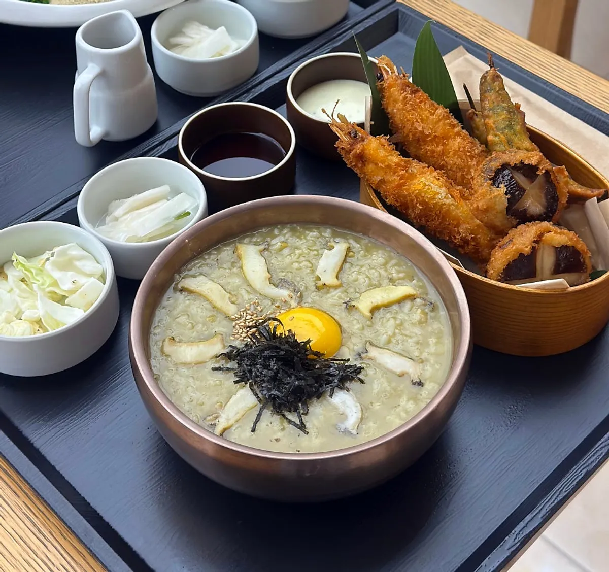 Table spread with abalone porridge, abalone perilla oil buckwheat noodles, and assorted tempura