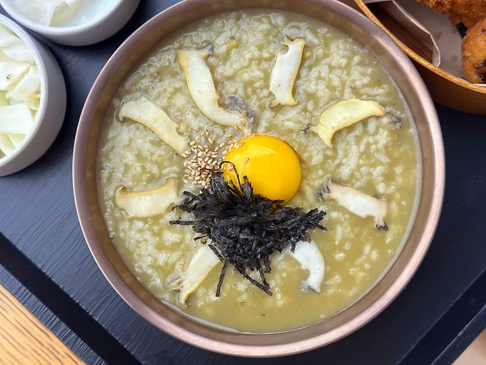 Abalone porridge served with cabbage salad and baek-kimchi