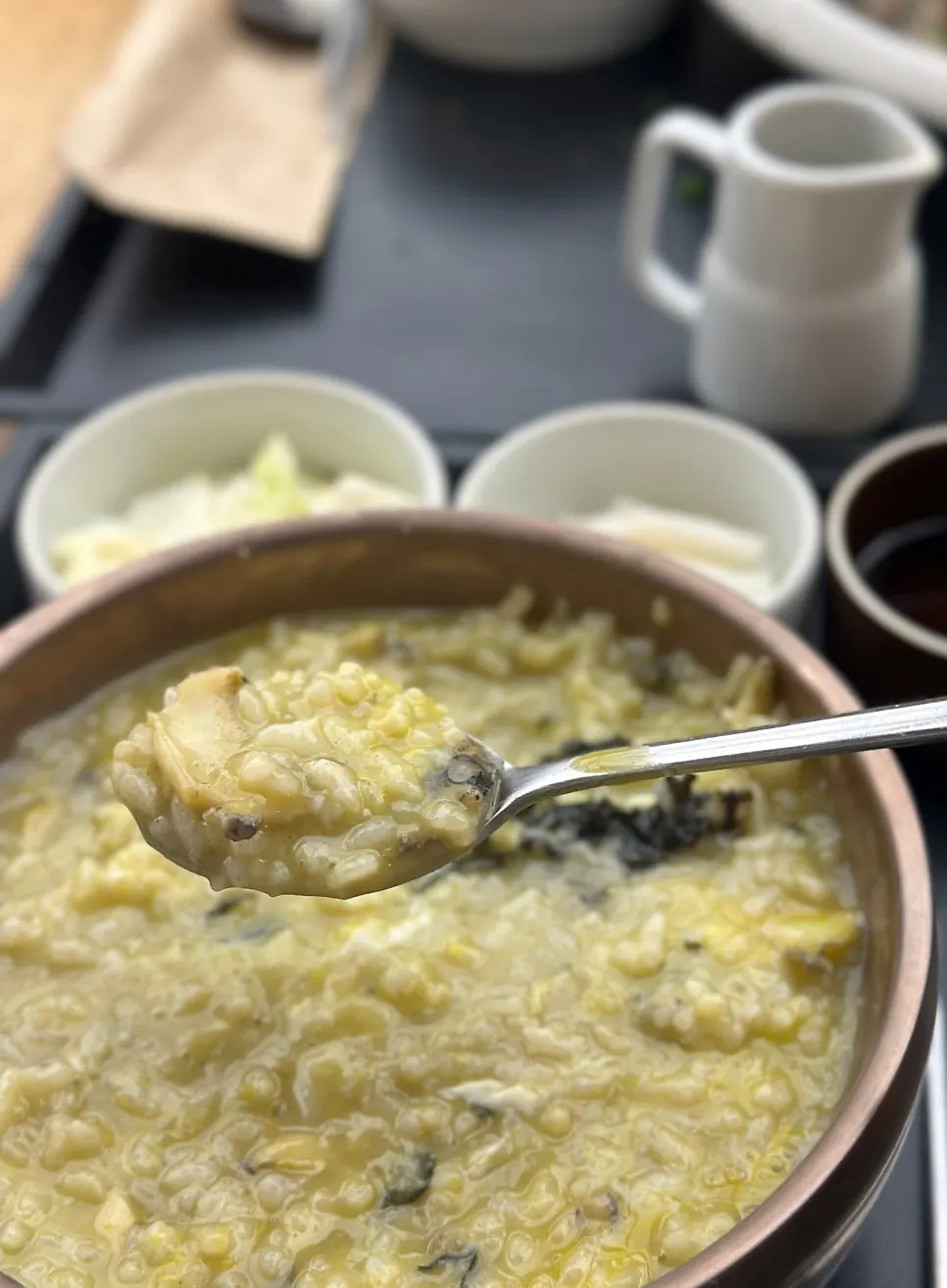 Spoonful of abalone porridge mixed with egg yolk