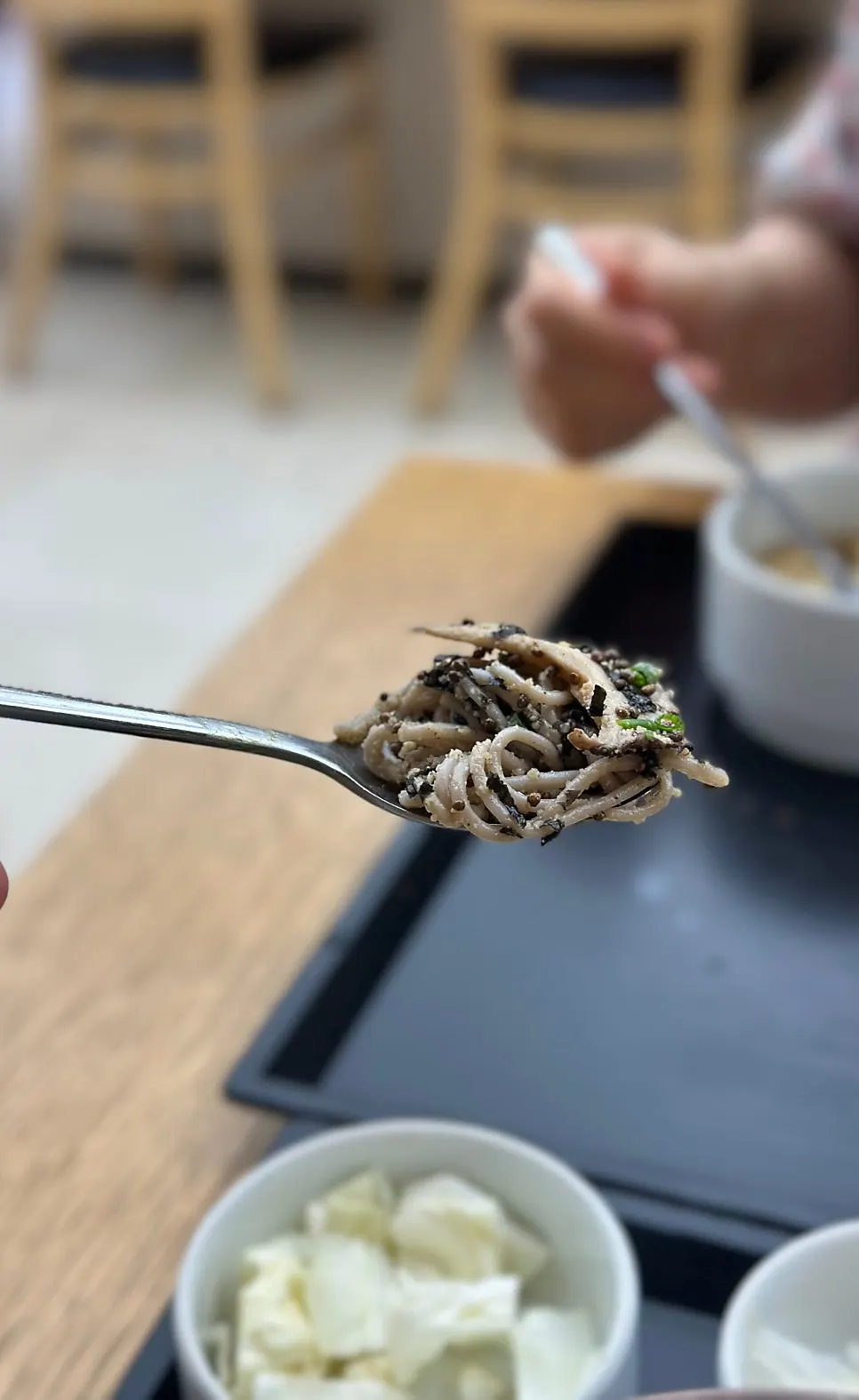 Abalone perilla oil buckwheat noodles topped with ground perilla seeds, mushrooms, and scallions