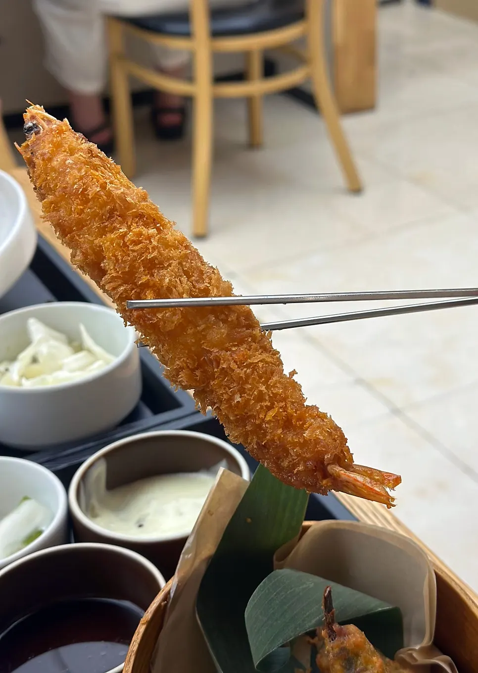 Cross-section of shiitake mushroom tempura dipped in soy sauce