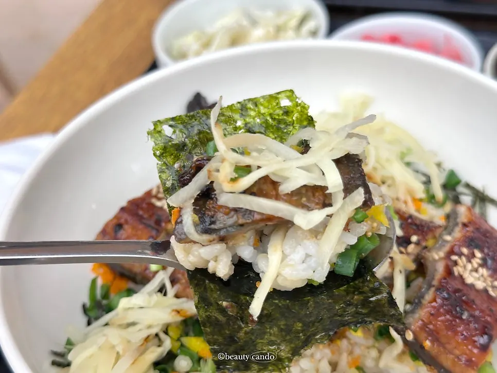 Eel rice bowl eaten down about halfway