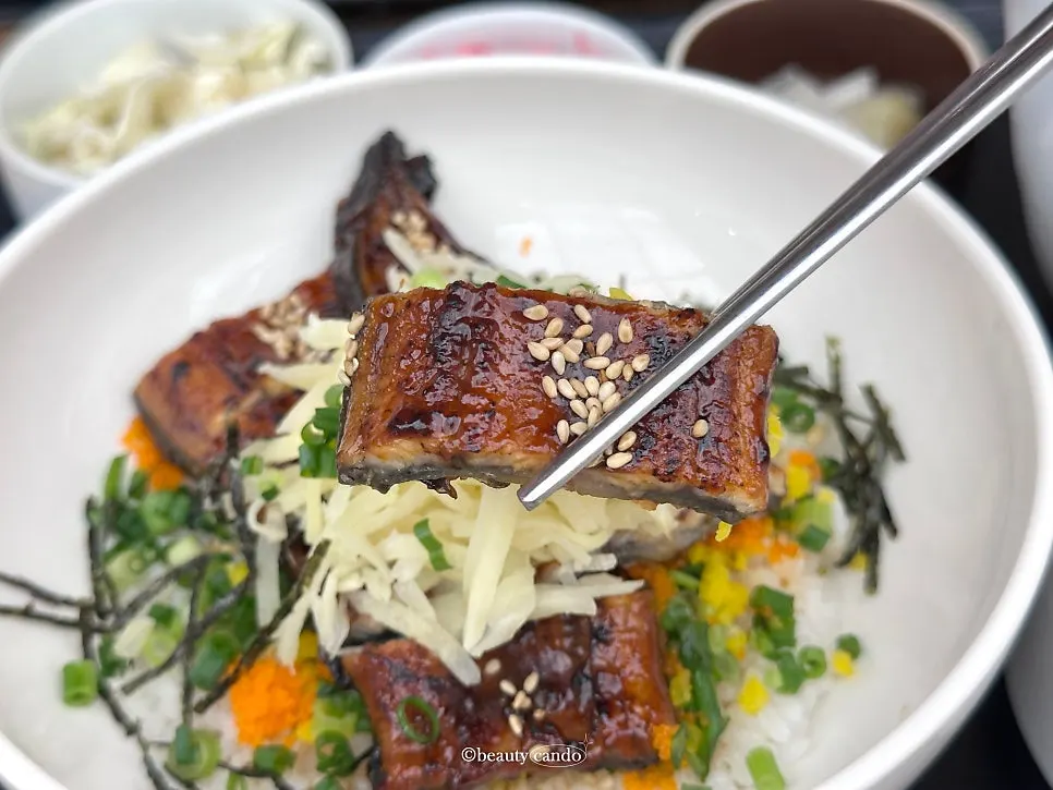 Eel rice bowl left with a portion remaining before pouring in tea