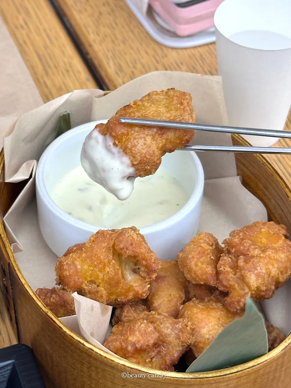 A piece of karaage dipped in sauce