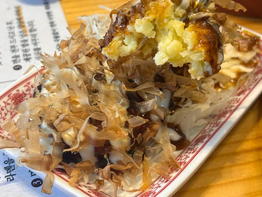 Mini okonomiyaki drizzled with sauce and mayonnaise