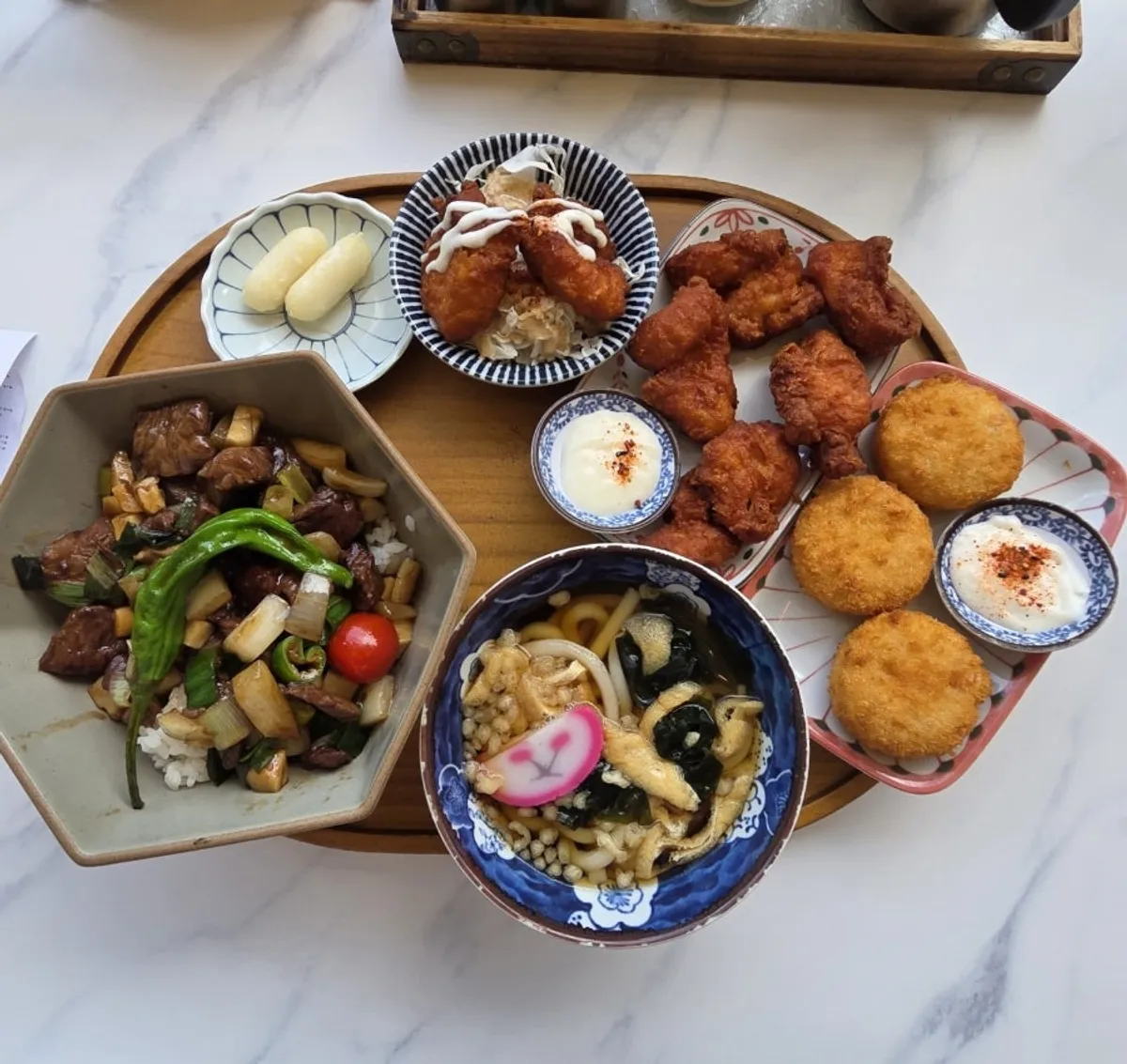 Cube steak rice bowl set with the extra fried chicken on the table