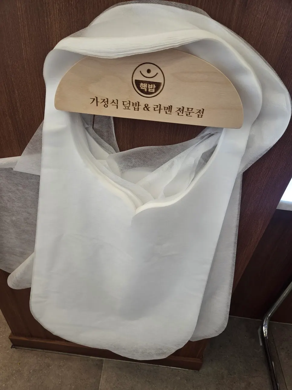 Napkin holder and disposable apron on the table