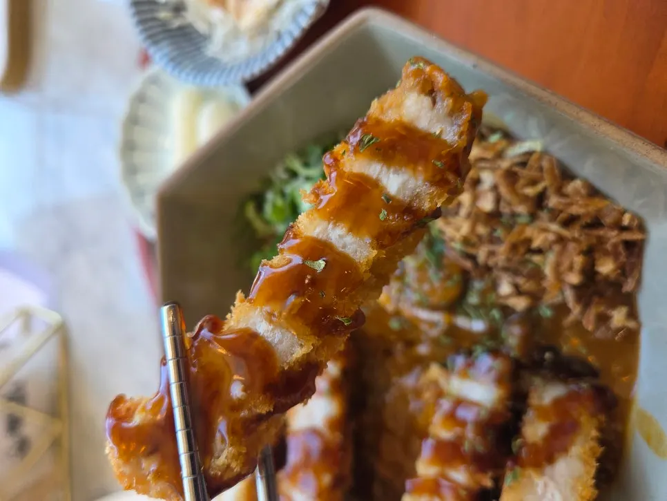 Close-up of pork katsu topped with curry sauce