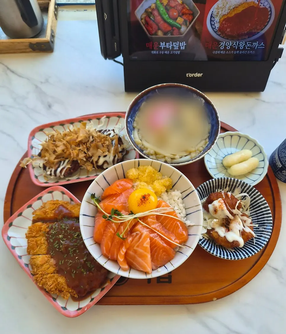 Full spread with salmon rice bowl, udon, and sides