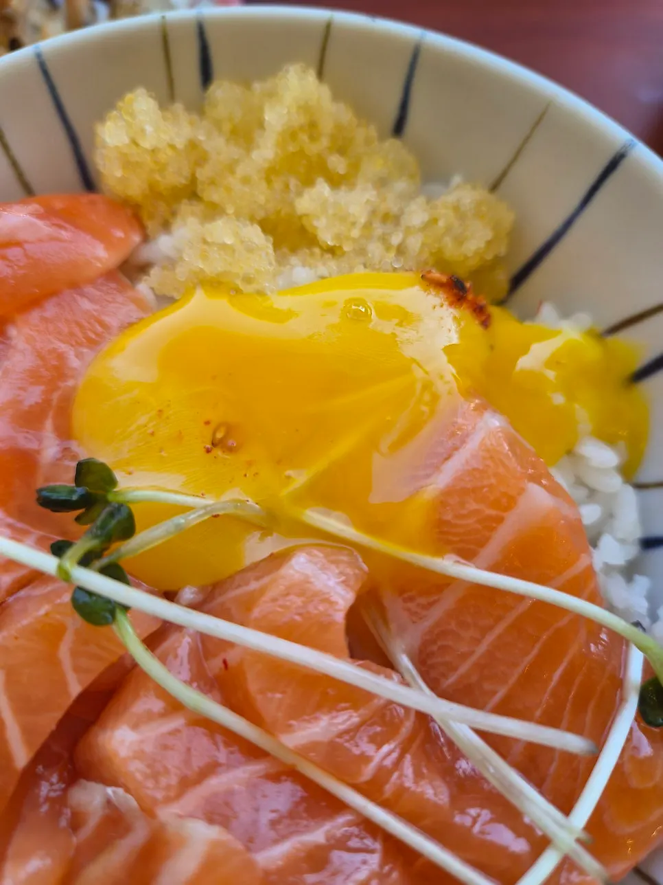 Close-up of the rice bowl topped with sliced salmon