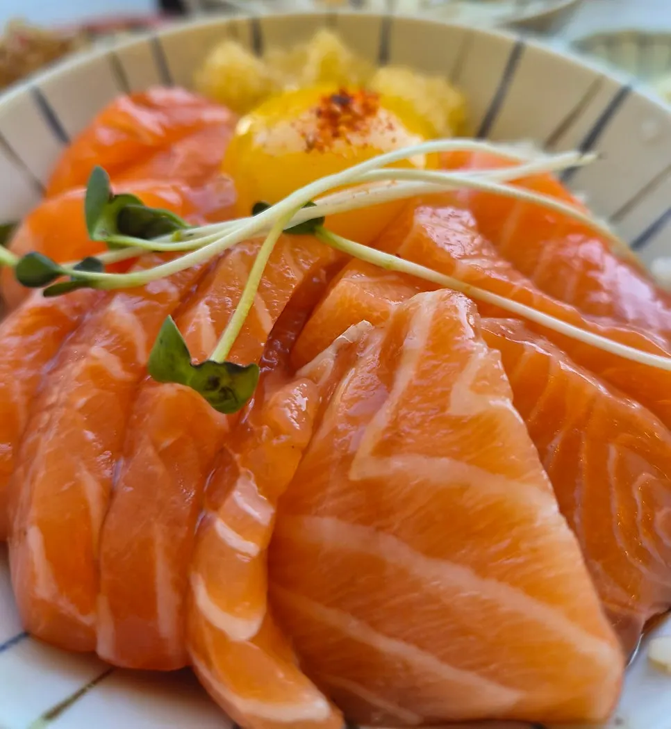 A spoonful of salmon and yolk mixed into the rice