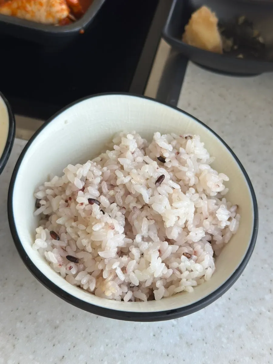 A bowl of rice next to the angler fish stew