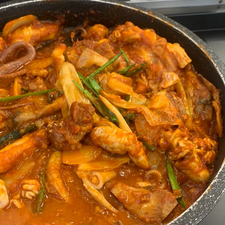 A bite of seafood braised ribs with rice