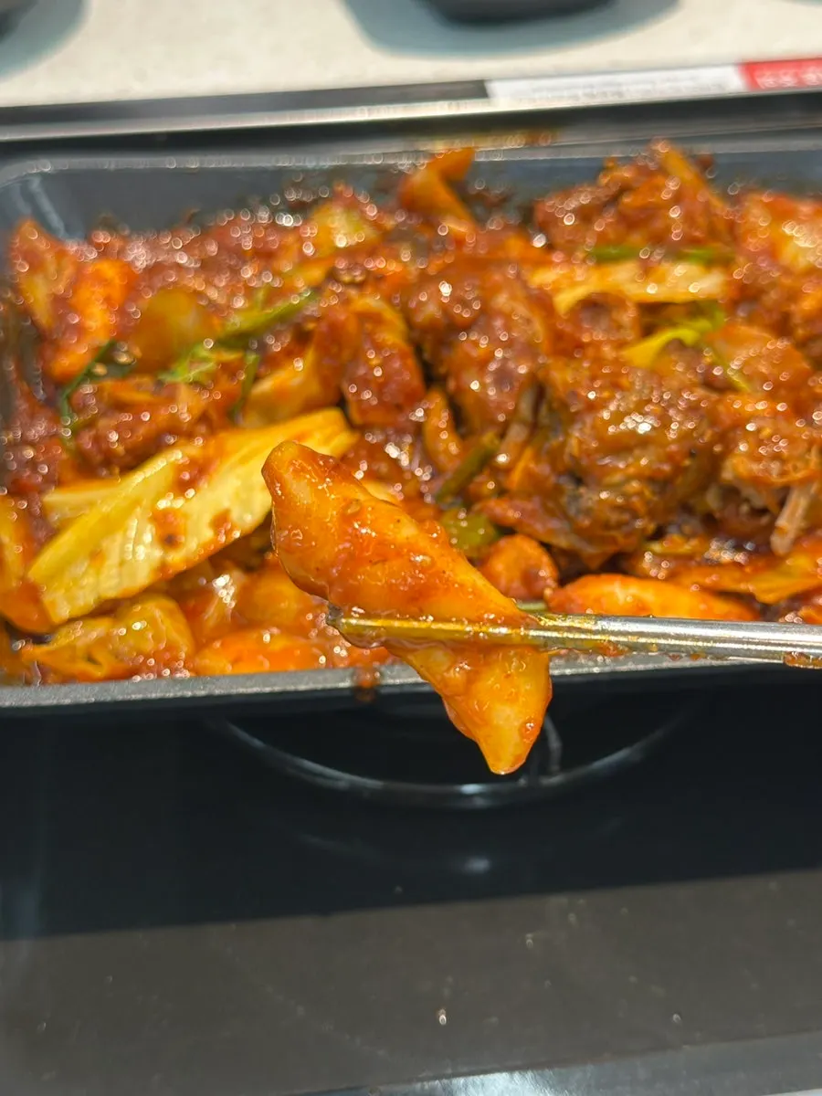 Tender braised pork rib meat sliding right off the bone