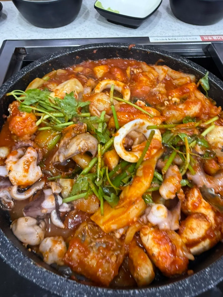 Seafood stew with whole squid and gonyi