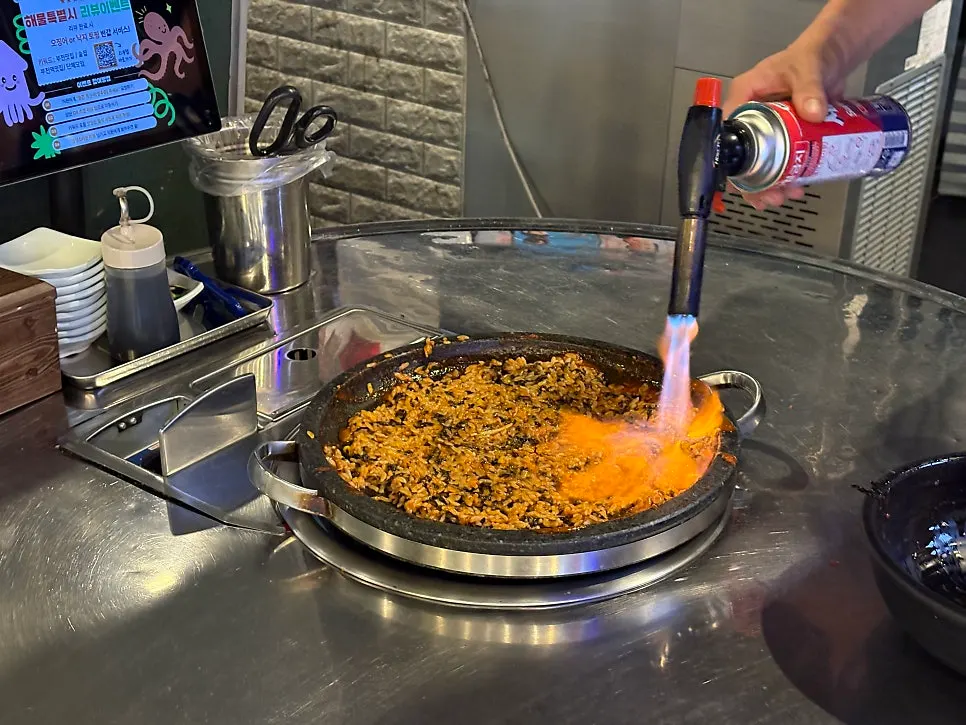 Fried rice being stir-fried at the table