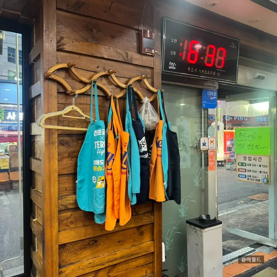 Aprons hanging on the wall with table setup