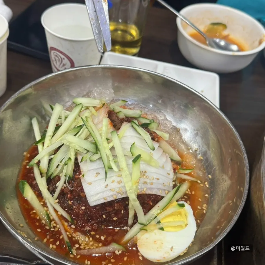Bibim-naengmyeon topped with egg and cucumber