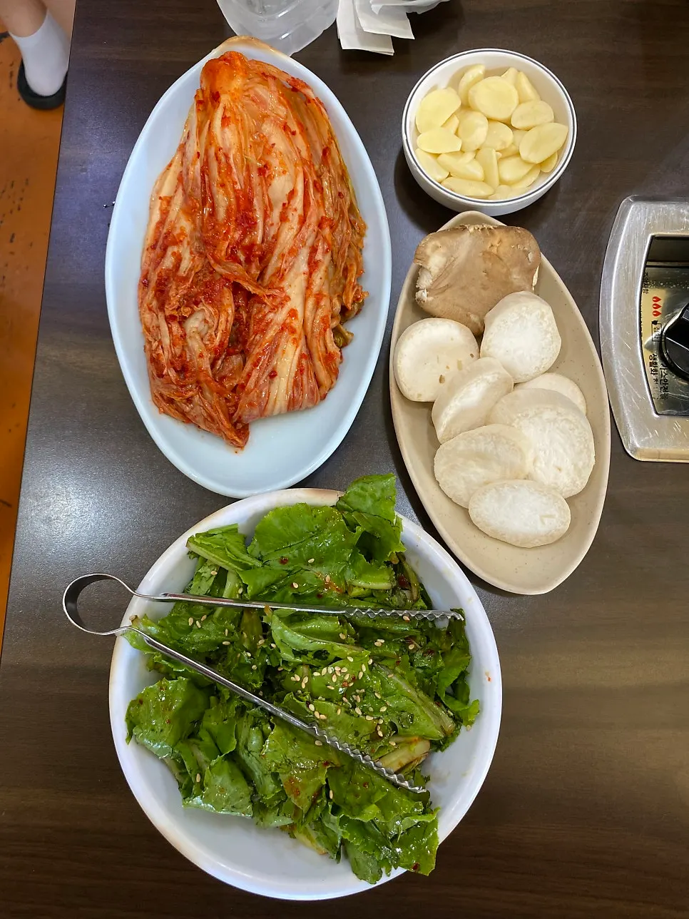 Basic side dishes with kimchi, garlic, and lettuce wraps