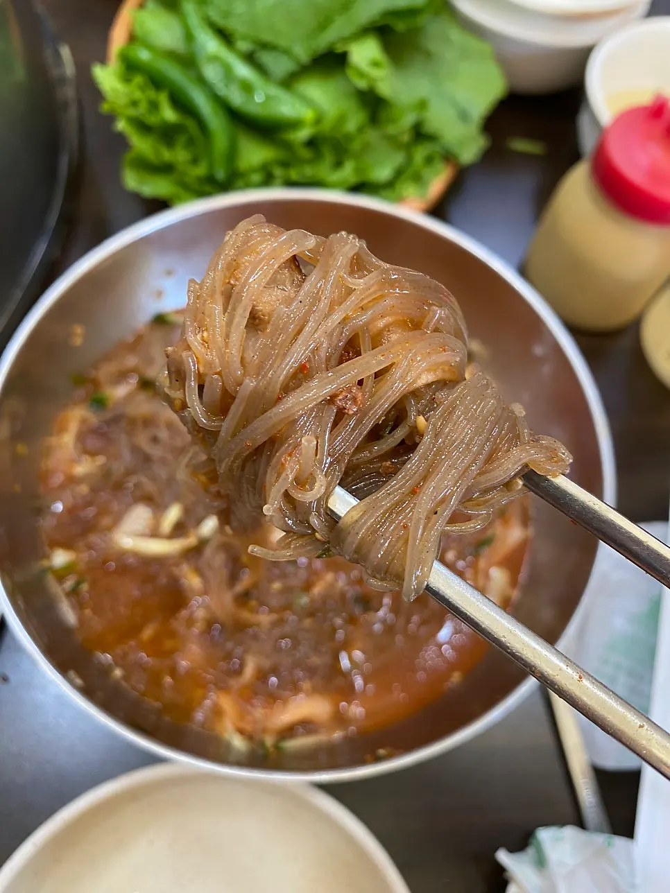 Bibim naengmyeon with icy slushy broth poured over it