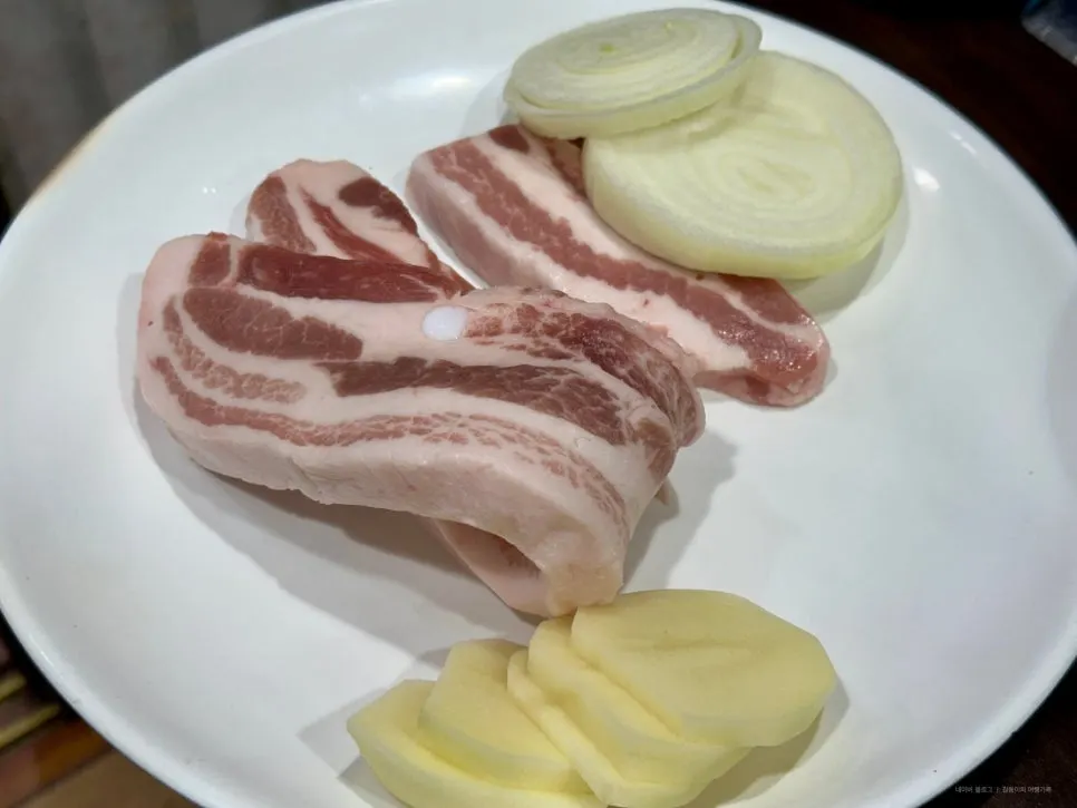 Two servings of ordered raw pork belly