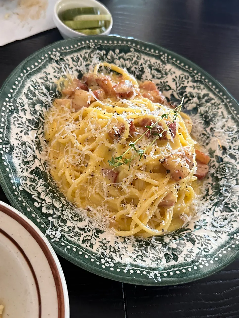 A plate of thick, creamy classic carbonara