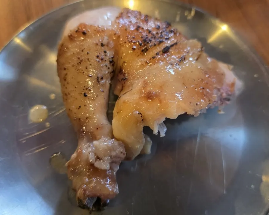 Oak-fired chicken meat dipped into the hot-plate sauce