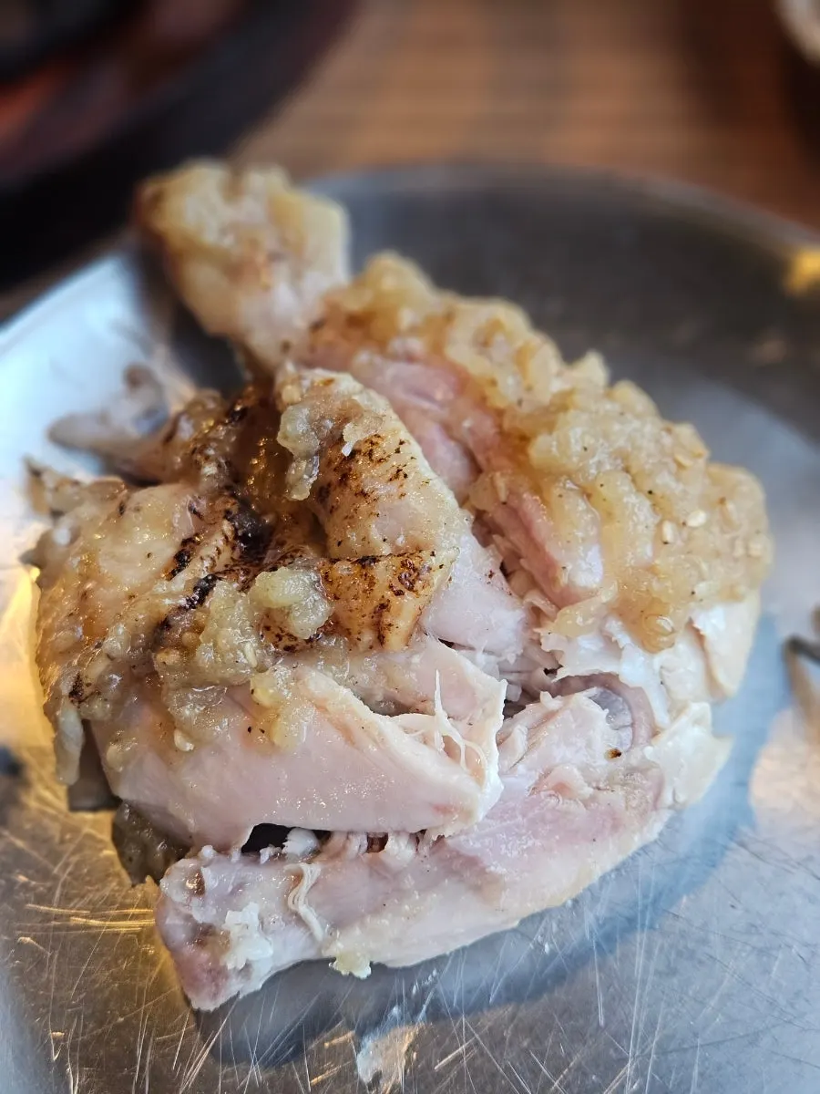Torn pieces of the whole roast chicken