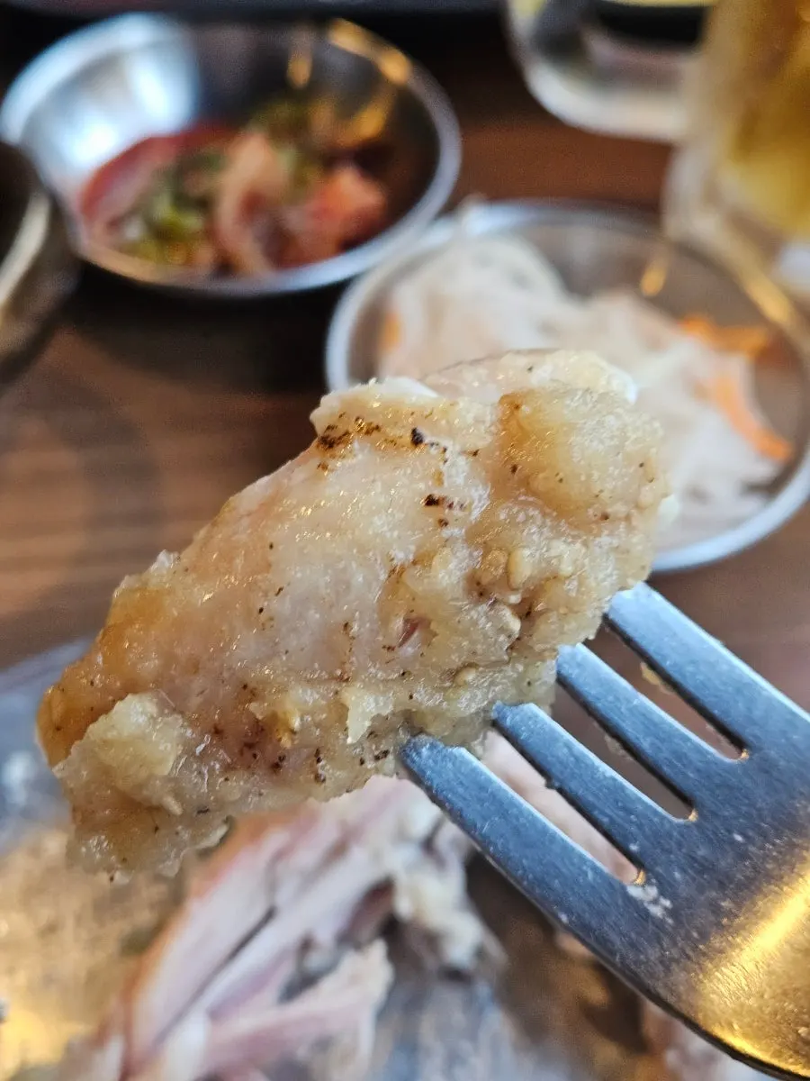 A piece of chicken dipped in wang-galbi sauce